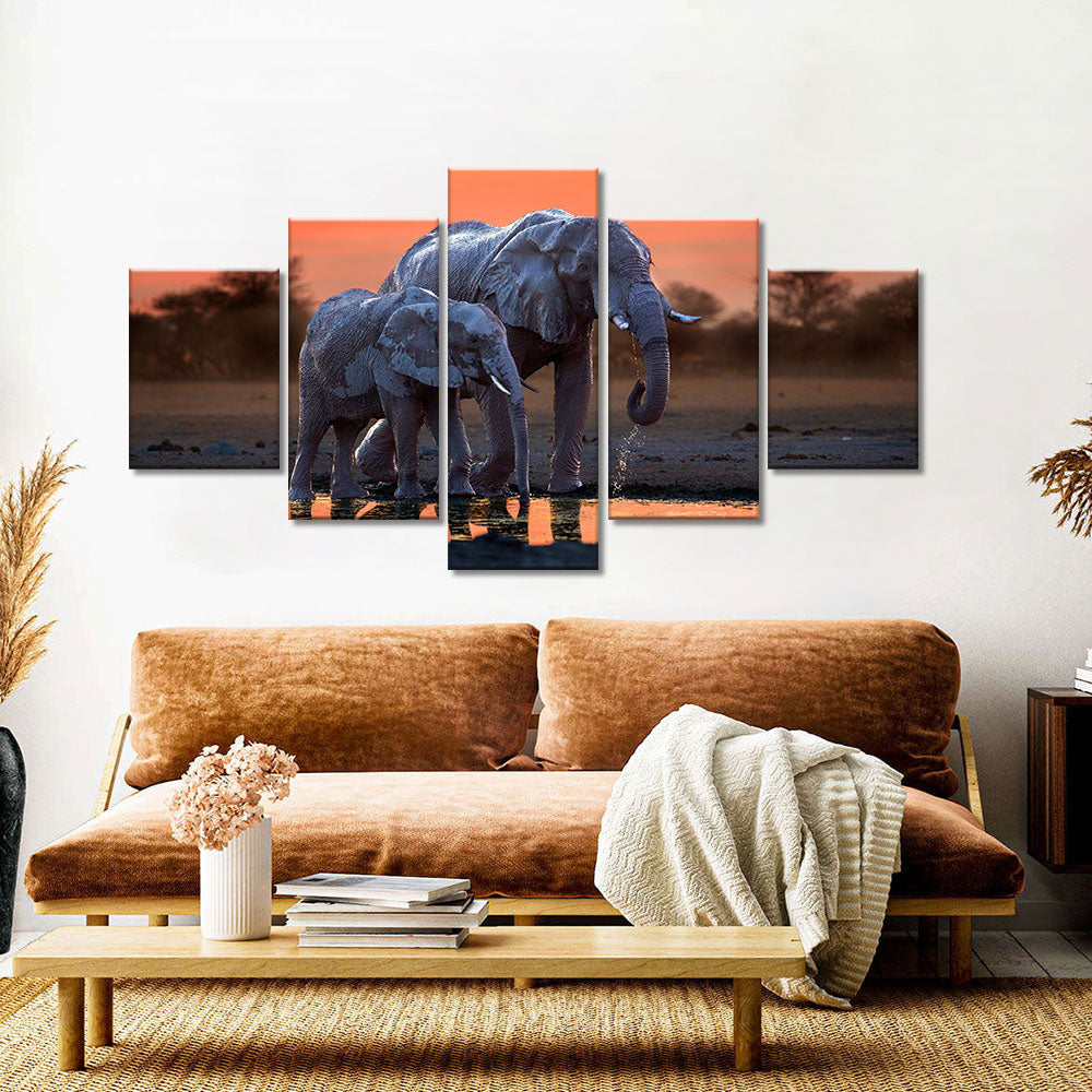 Elephant walking with baby in sunset canvas wall art